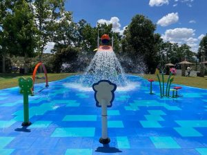 Inside view of a blue-colored splash park featuring gomy floor surfaces
