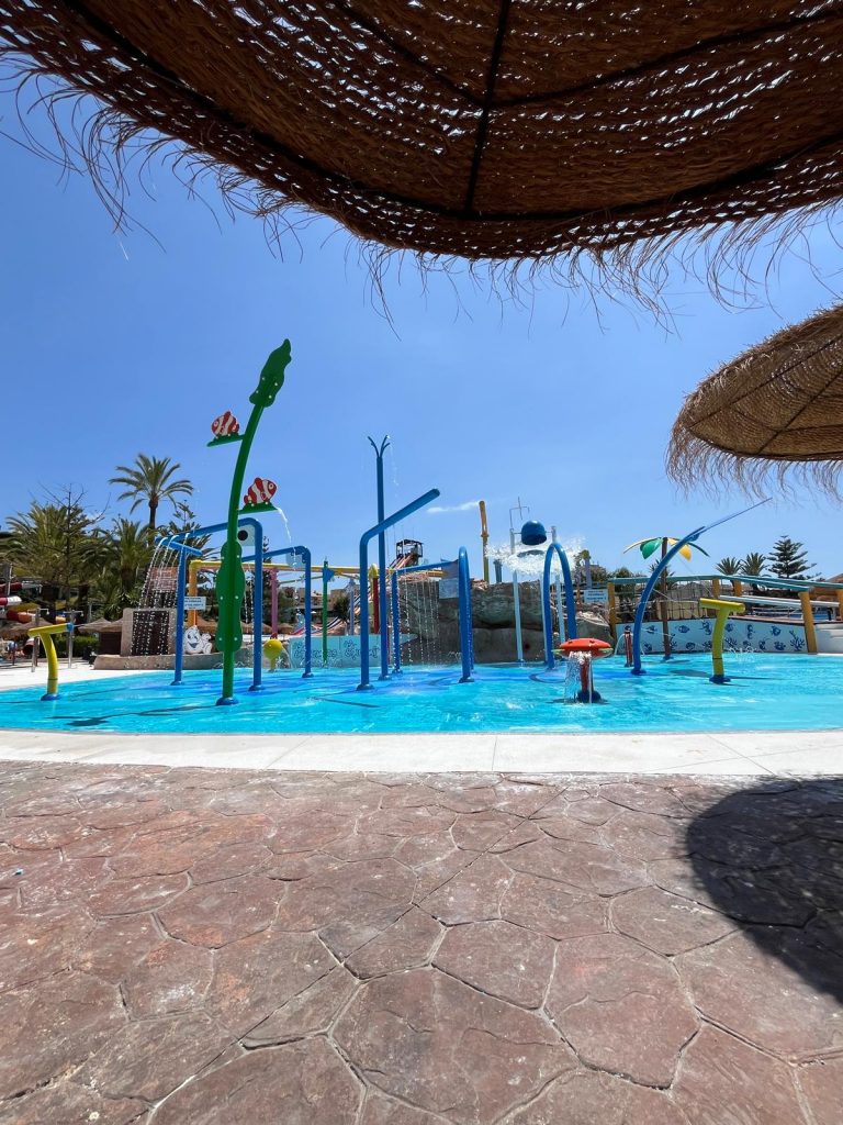 Side view of a water park flooring with water play equipment
