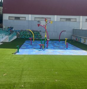 Far view of a square splash pad with waterfun equiiped products and floor