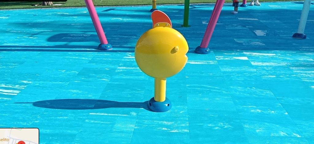 Close up view of a water feature standing over the aquatic blue surfaces