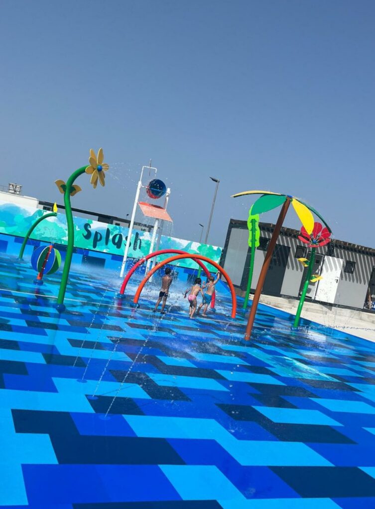 External view of the splash pad featuring gomy floor tiles, providing safety to the kids!